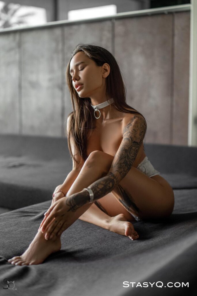 Russian stunner with tattoos slips out of her outfit to reveal a perfect body